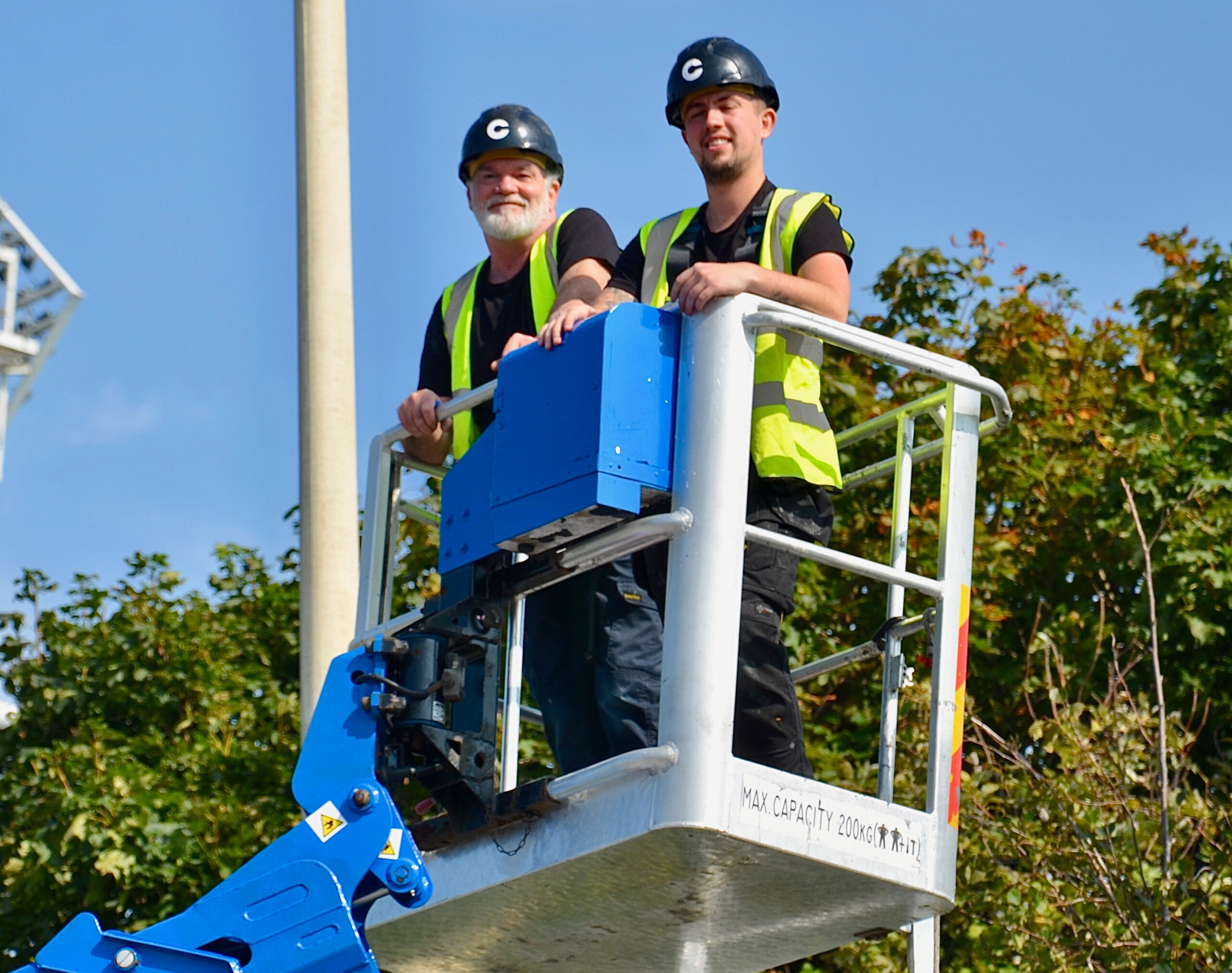 Sam and Steve from the print room department working on a cherry picker